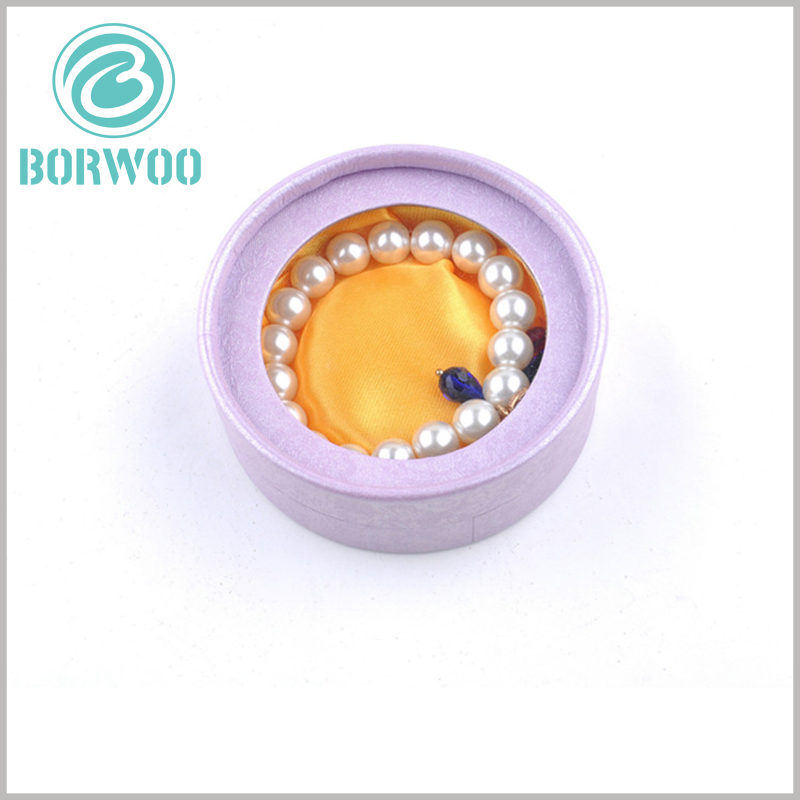 Custom small round boxes with windows for bracelet packaging.Light purple as the main hue of paper tube packaging design