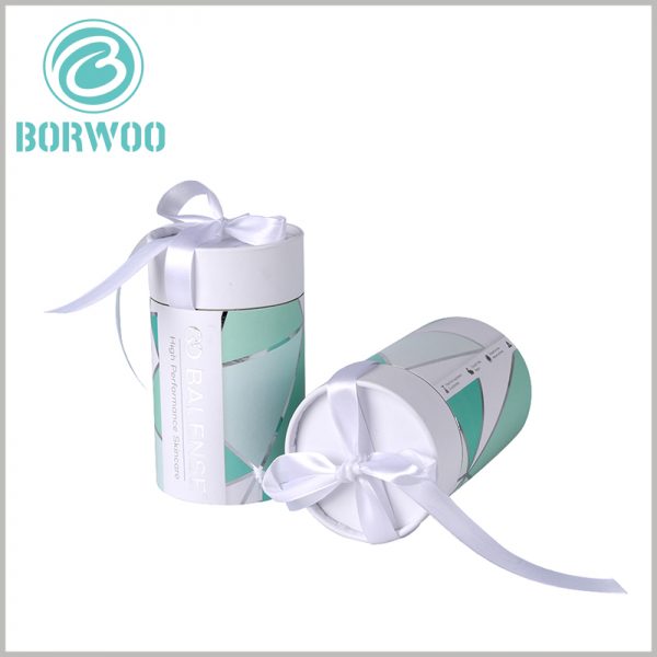 Large cardboard tube packaging for skin care gift boxes.Smooth white silk scarves add value to skin care packaging.