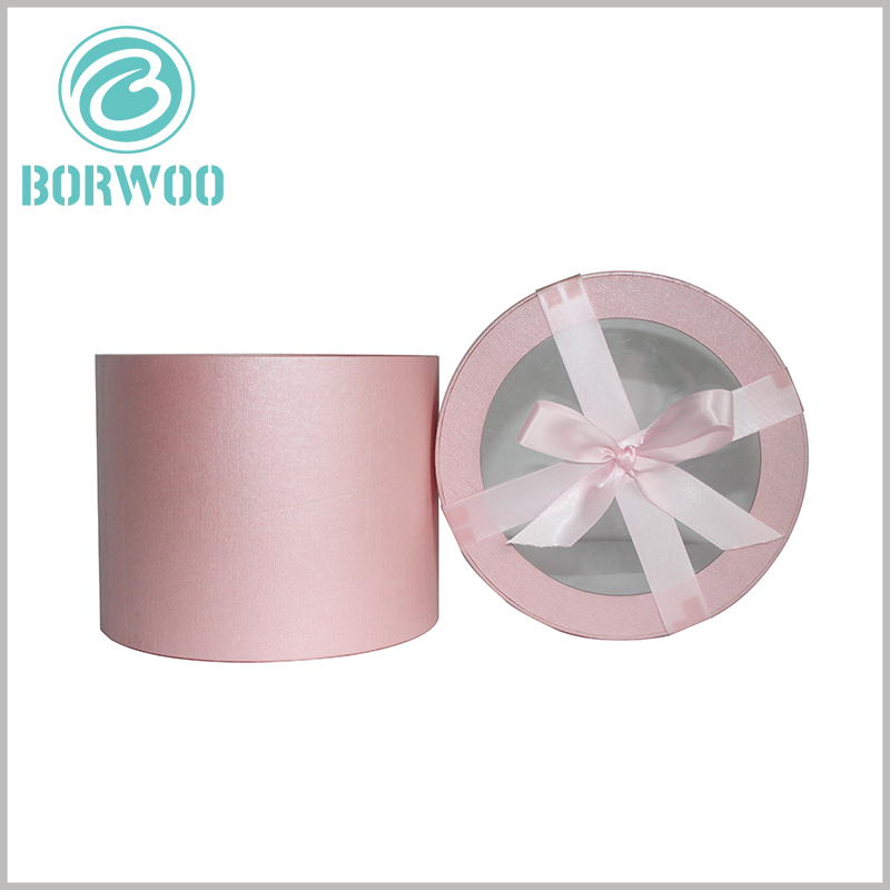 Pink round cardboard tubes gift packaging with window.The pink packaging background is loved by many women and will help attract consumers' attention and sell products.