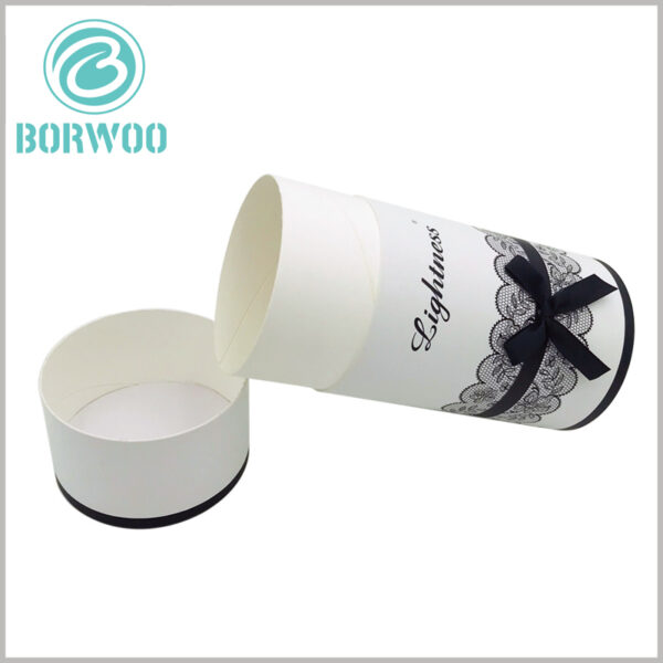 White cardboard tube gift boxes packaging with printing.Lace print adds to the viewing of the package, and the black silk scarf gift knot enhances the decorative packaging of the tube.