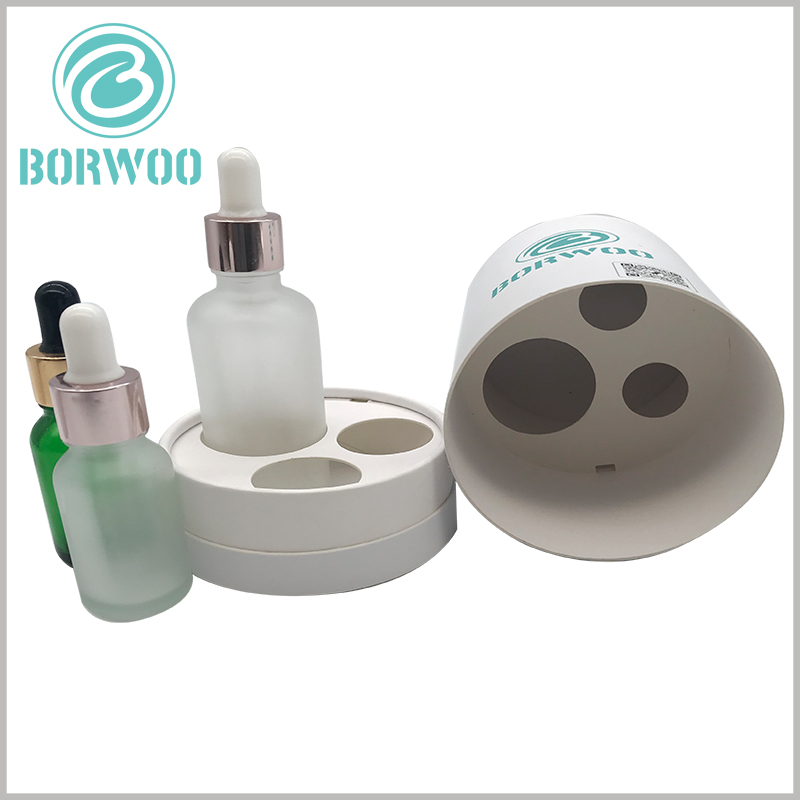 white Essential Oil Packaging Tubes with Paper Inserts, using different holes in the paper card to accommodate different types of essential oil bottles